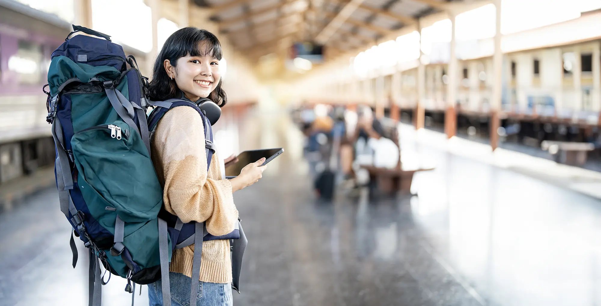 A female traveller with a backpack, about to embark on a journey