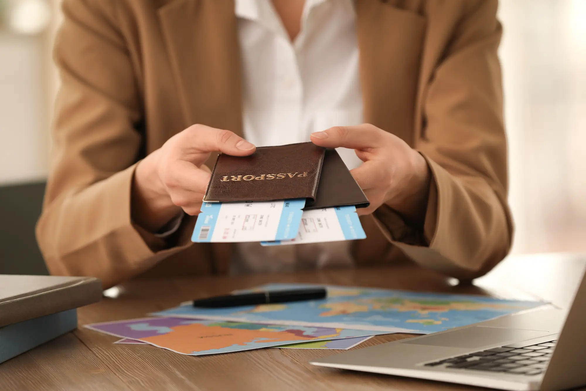 A person handing over a passport with both hands